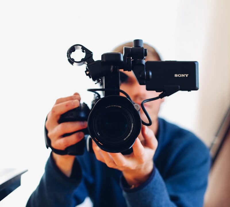 person holding DSLR camera