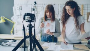 Two women record a tutorial video together.