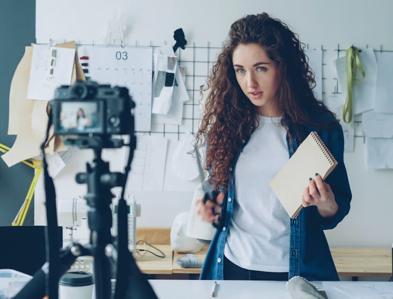 Woman records a video about sewing and fashion.