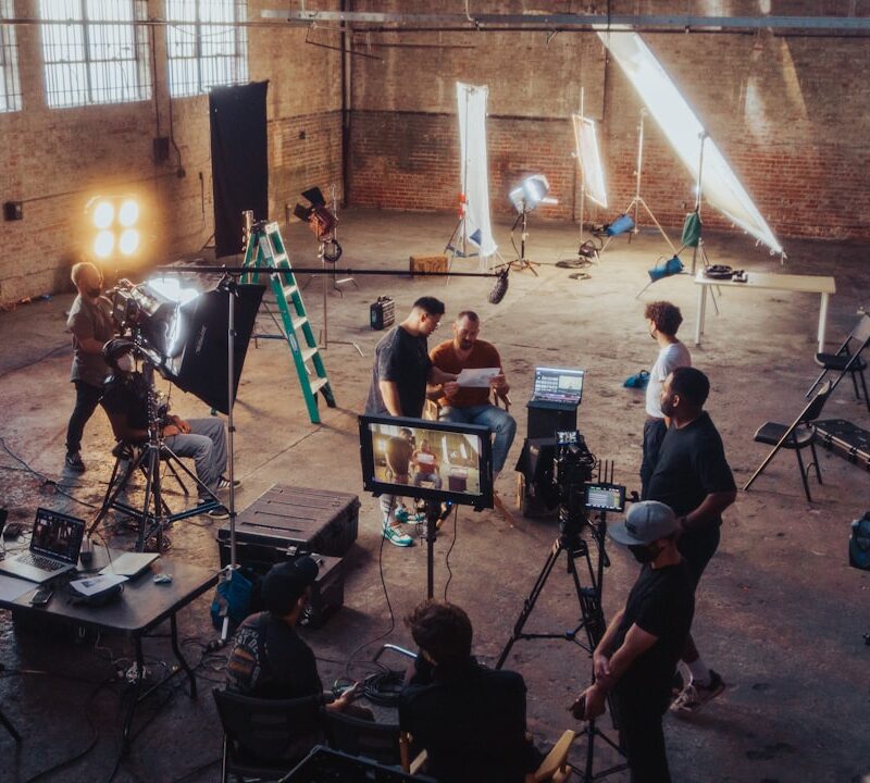 a group of people standing around a camera set up
