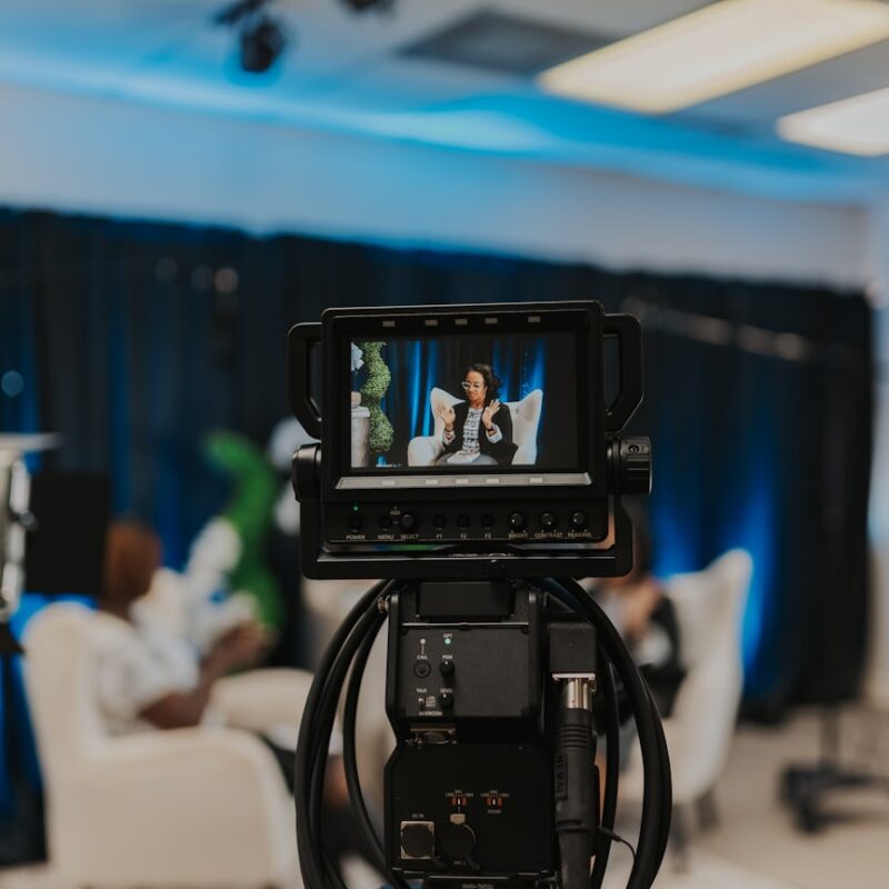 a camera set up in a room with people in the background