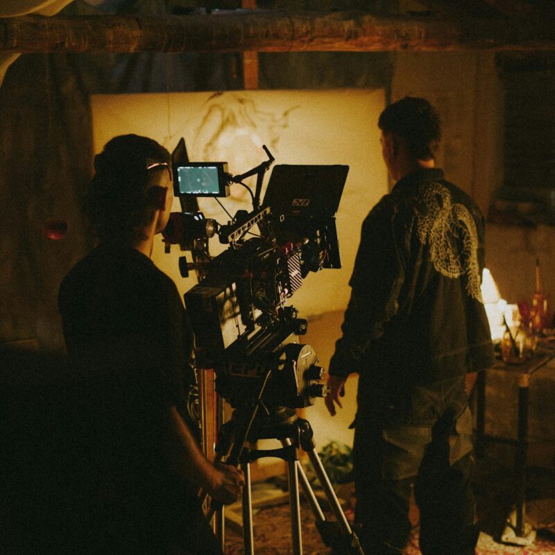 a couple of people standing in front of a camera