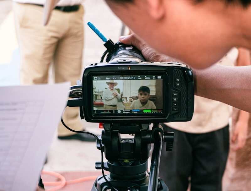 a person holding a camera with a video on it