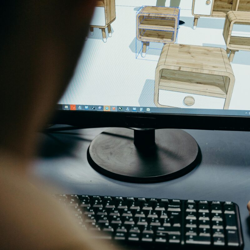 Close up of a monitor with 3D renders of end tables lined up in rows