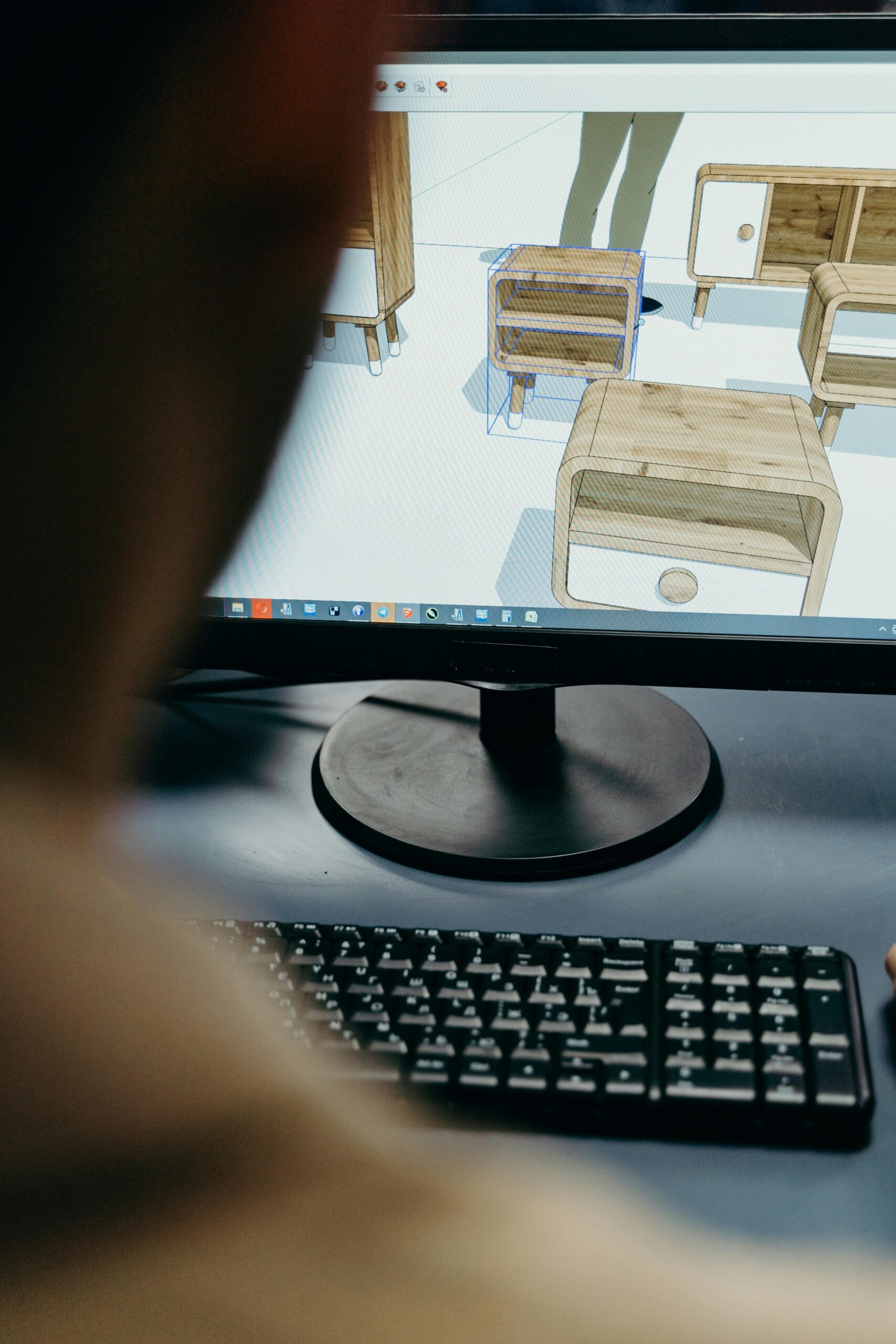 Close up of a monitor with 3D renders of end tables lined up in rows