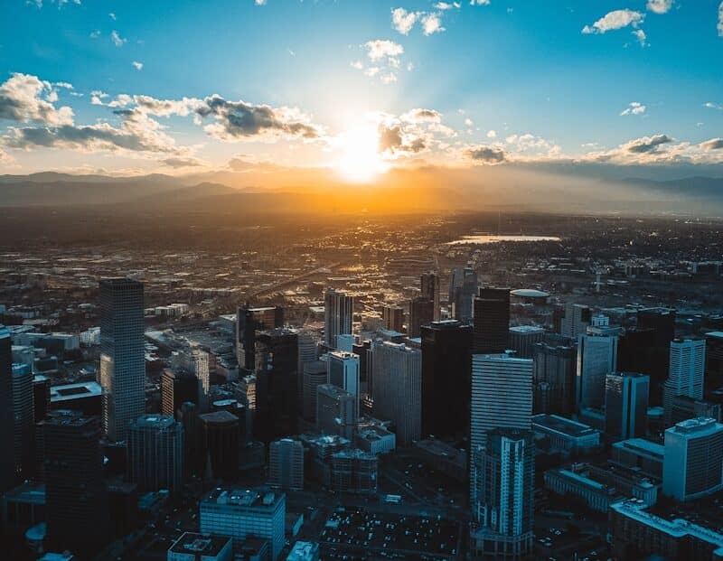the sun is setting over a large city