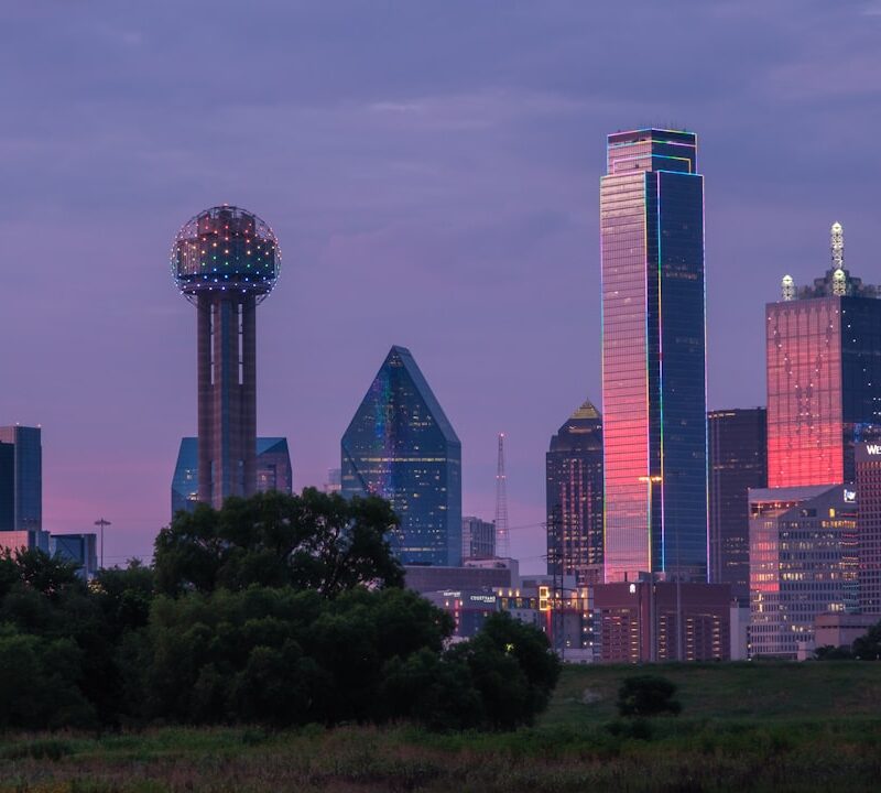 a view of a city skyline with a water tower in the foreground